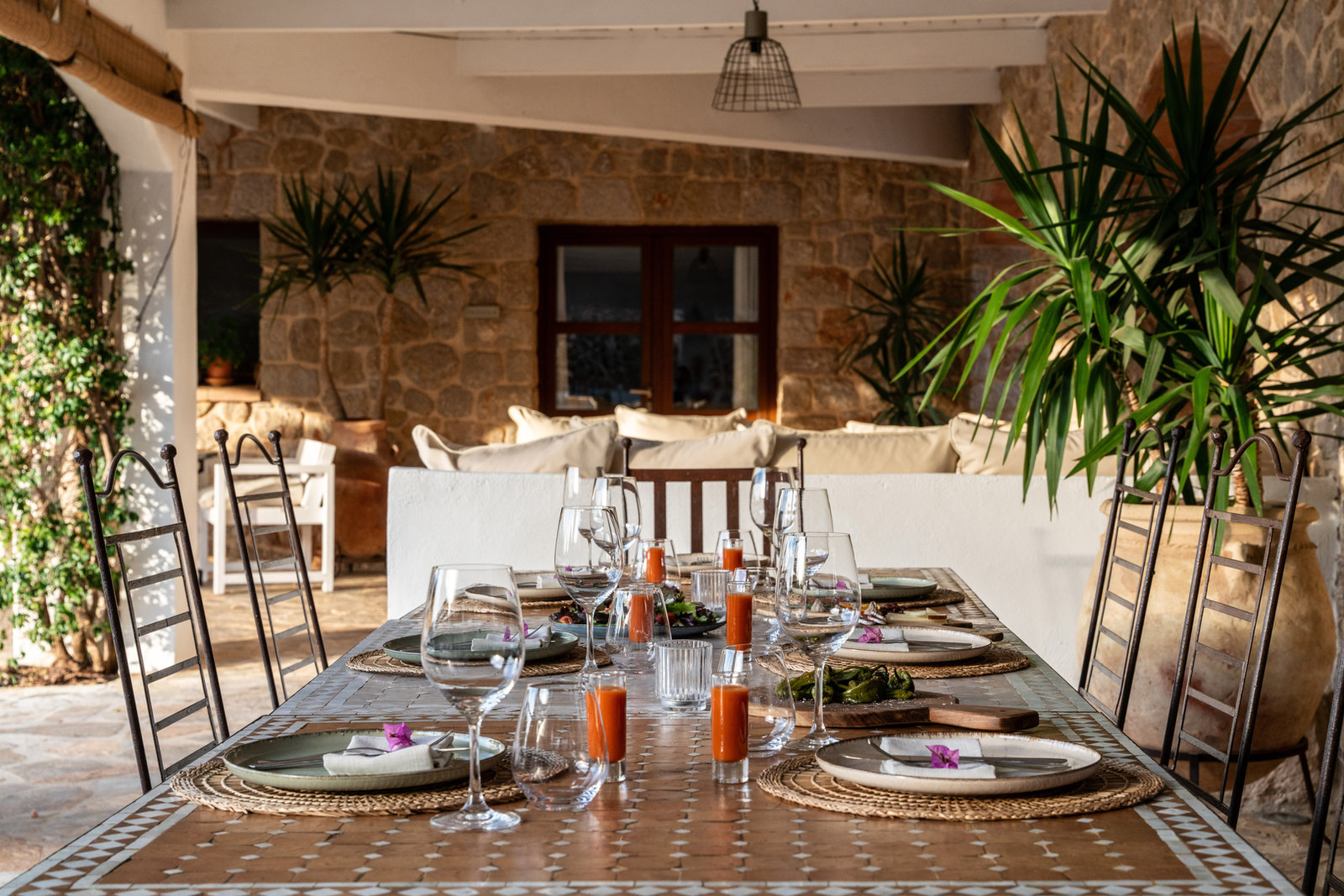 A long dining table set for a group dinner at the finca