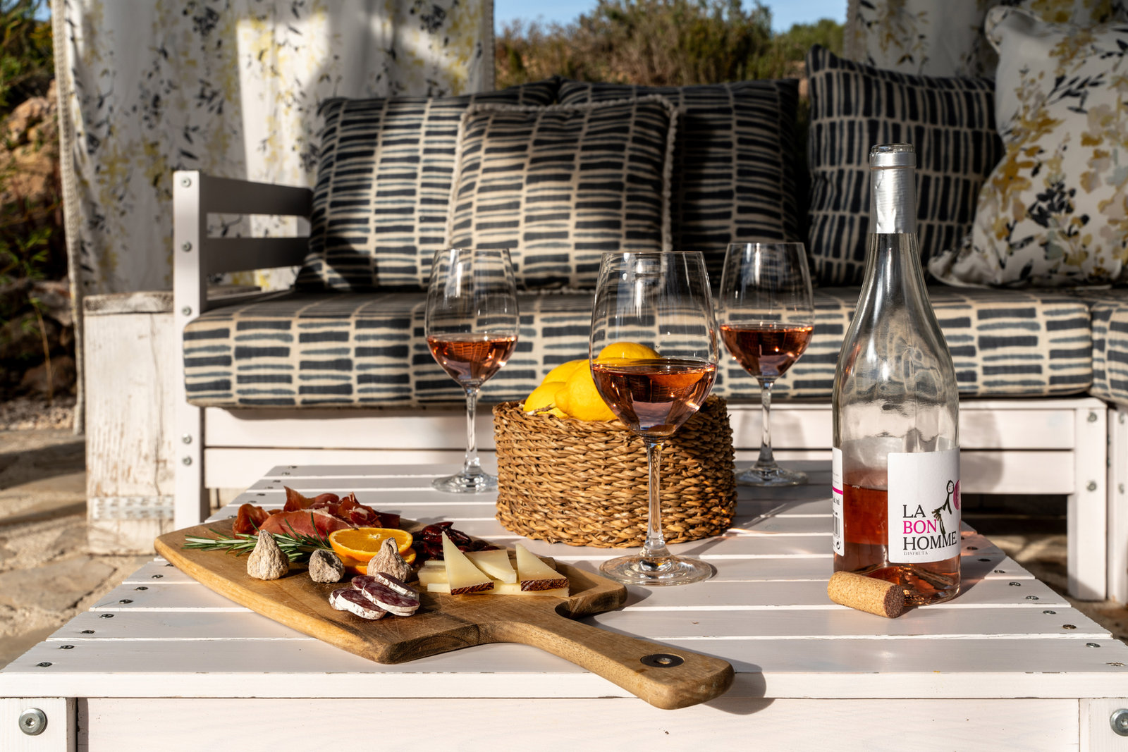 A picnic spread with local wine on a bench in the valley