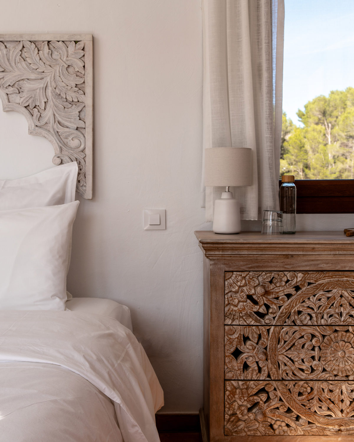 Bright bathroom with carved wooden vanity at Cuatre Finques