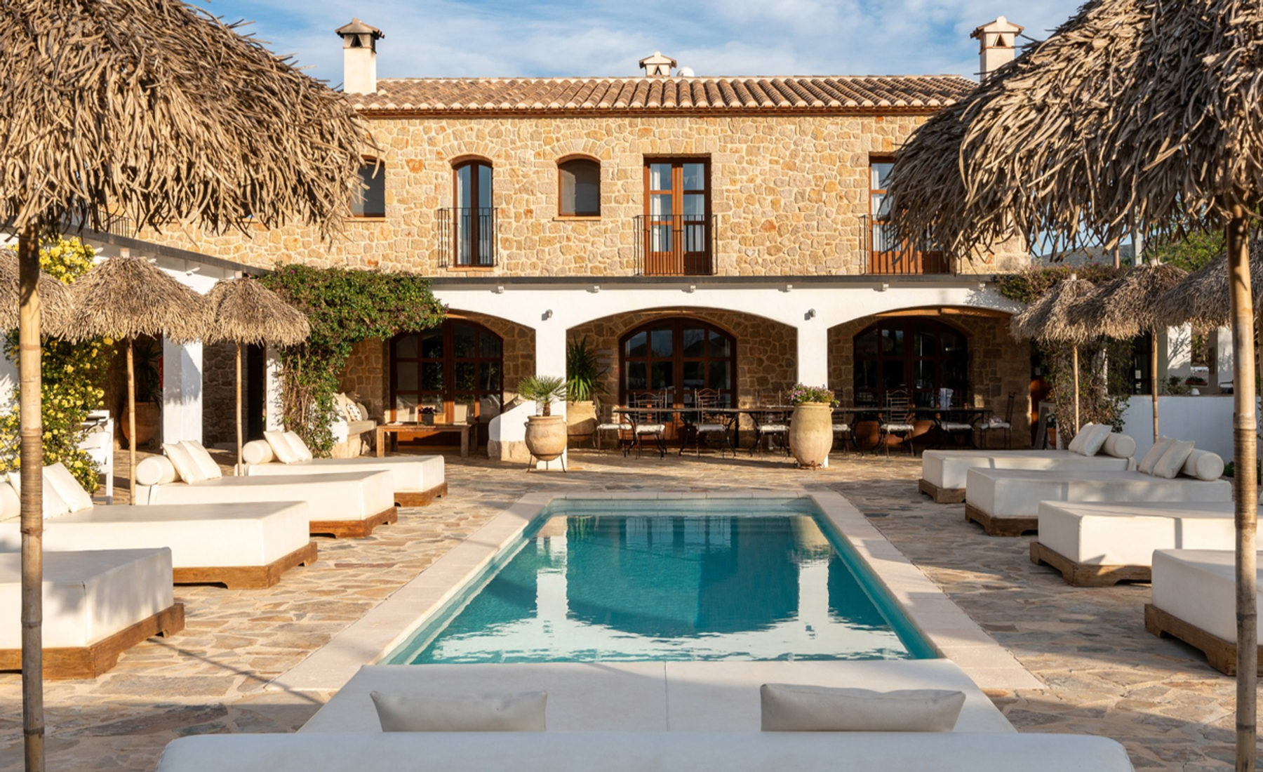 The pool and sun loungers in the gardens of Cuatre Finques